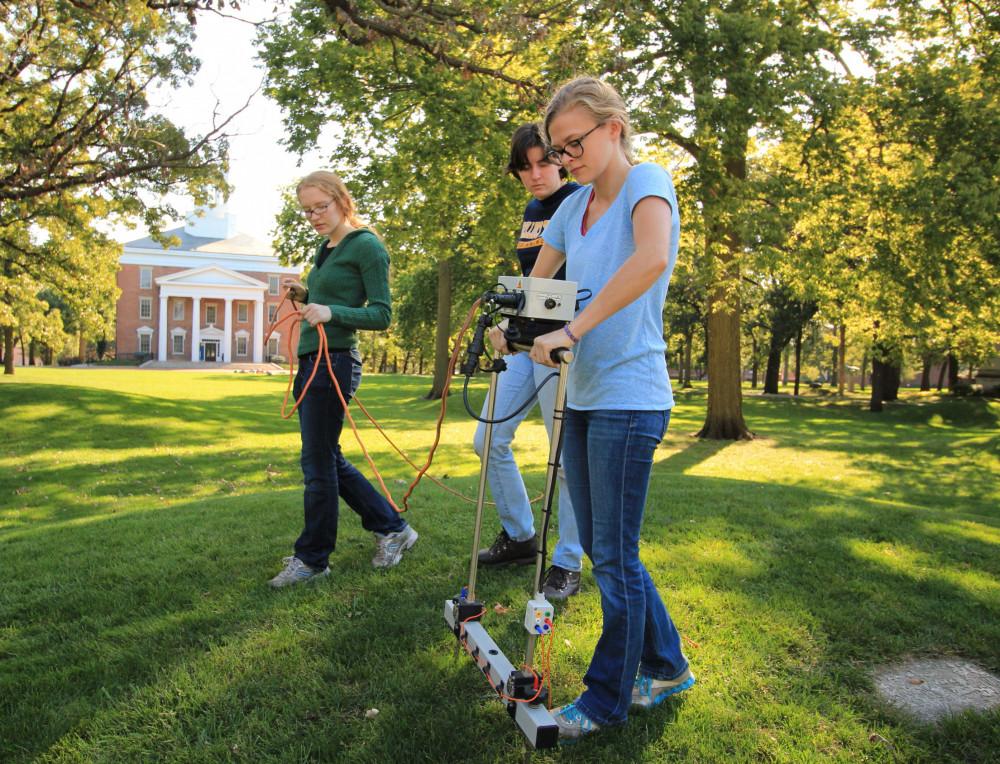 Beloit archaeology students pass a ground imaging machine over one of the ancient Indian mounds on campus.